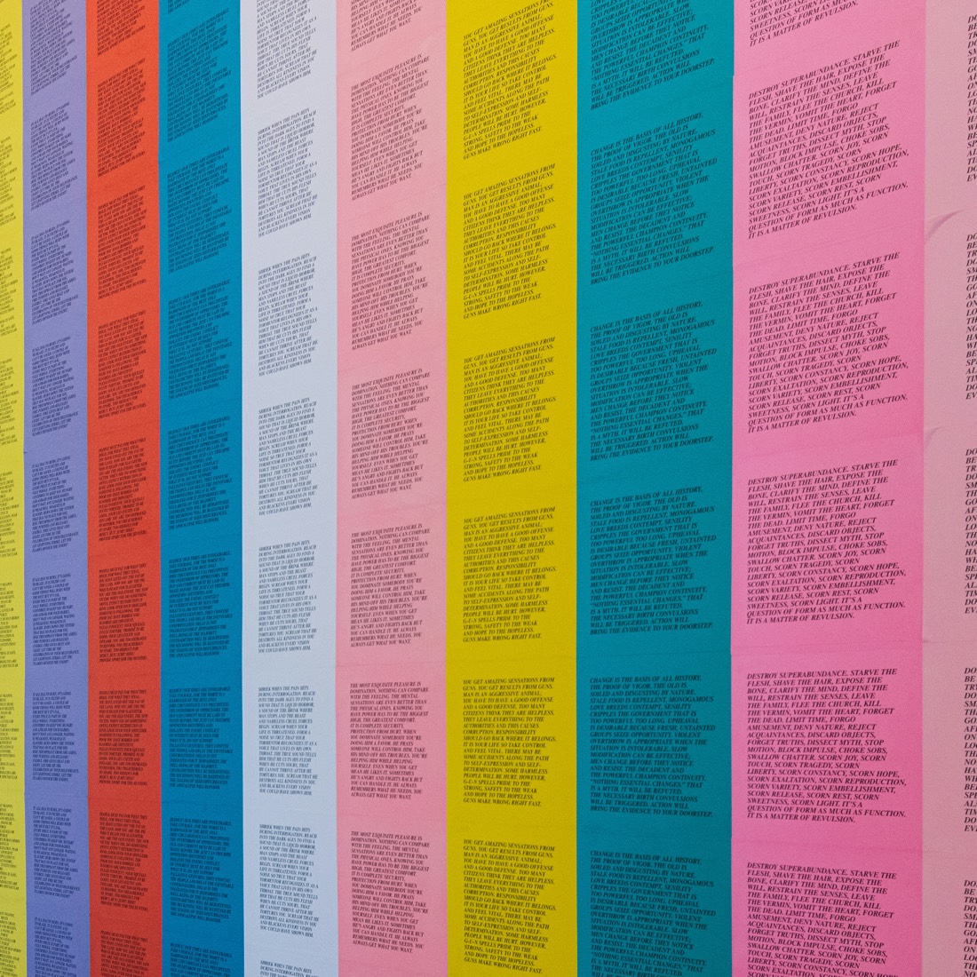 A wall of brightly colored printed posters